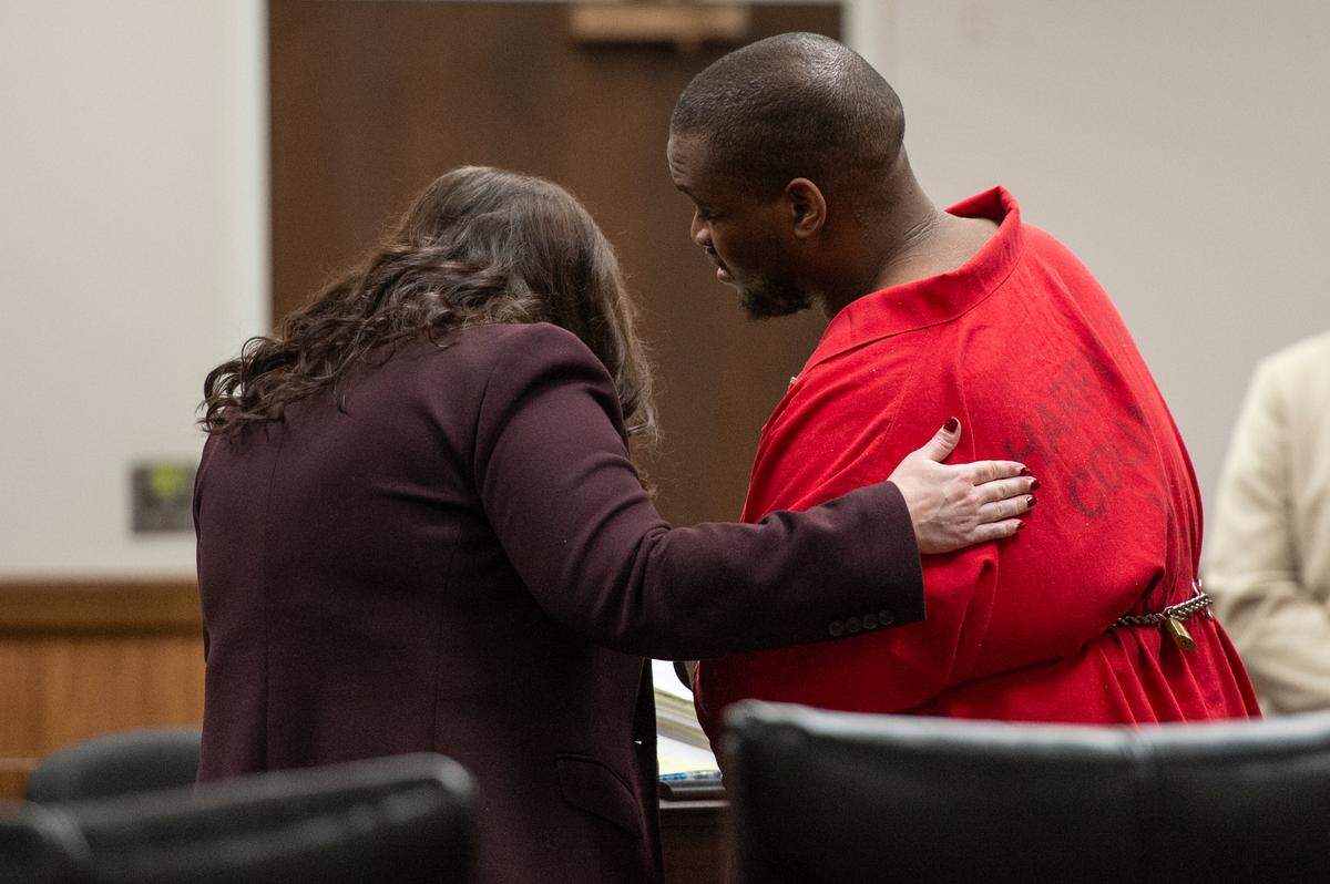 Andrew Malik Jones, who is accused of raping a woman at an outlet mall, talks to his attorney Angela Broun during his plea hearing at Harrison County Courthouse in Gulfport on Wednesday, Jan. 17, 2024. Jones pleaded guilty to three charges including sexual battery.