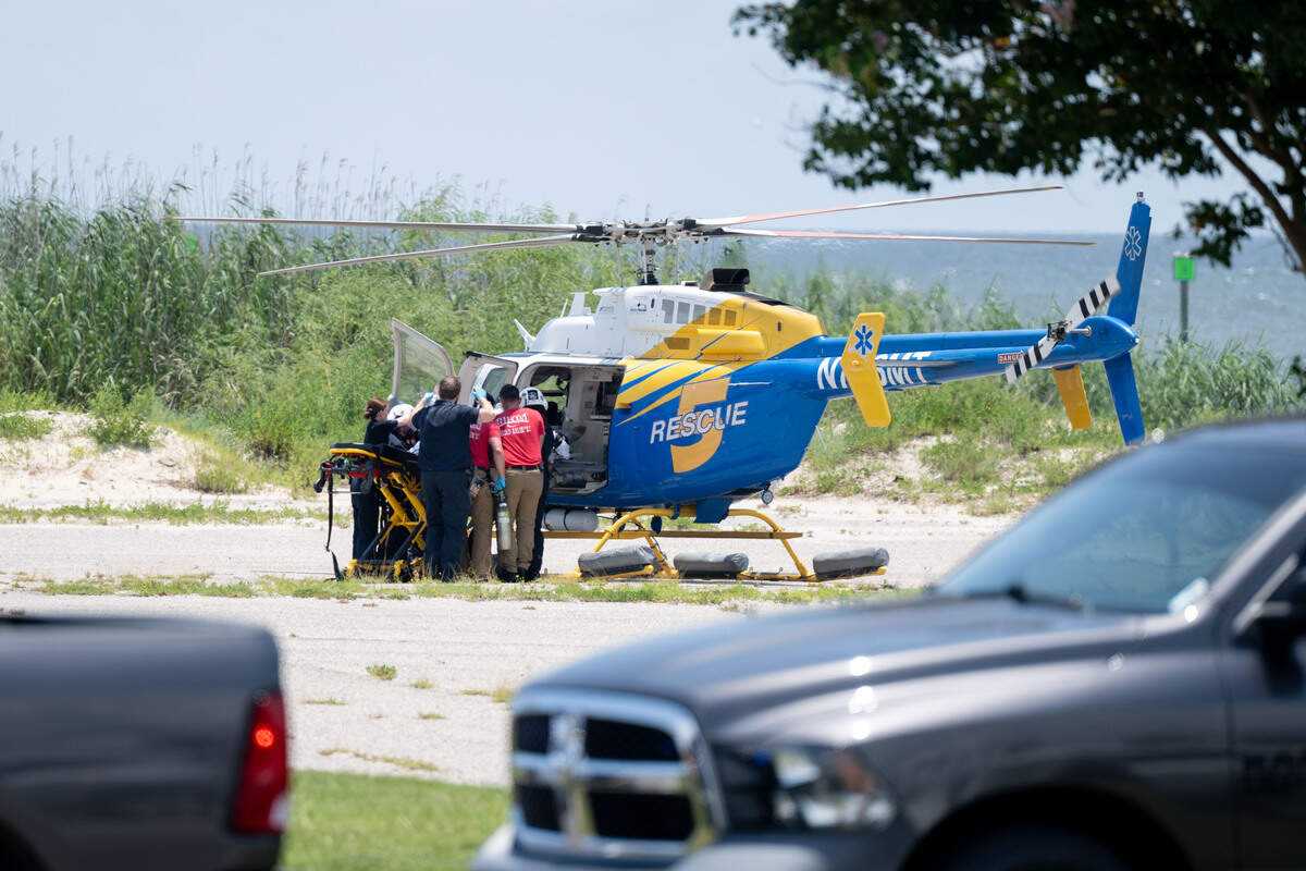 A rescue helicopter is loaded with an injured person at the scene of a shooting Wednesday near West Beach Boardwalk in Biloxi.