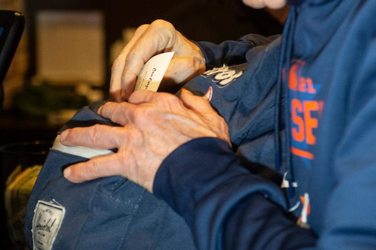 Jim McIngvale, better known as ‘Mattress Mack’, puts his ticket for a $500,000 bet on the winner of the NCAA Men’s Basketball Tournament into his famous Astros backpack at the Beau Rivage Casino in Biloxi on Tuesday, Nov. 15, 2022.