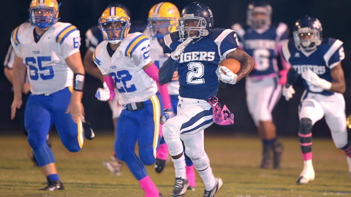 GLENN ANDREWS/SPECIAL TO THE SUN HERALD 
 Moss Point running back Travis Marion (2) outruns Bay noseguard Jared Truxillo (65) and cornerback Delfred Lewis (22) for a touchdown against Bay during the first quarter, Friday, Oct. 30, 2015, in Moss Point, Miss.