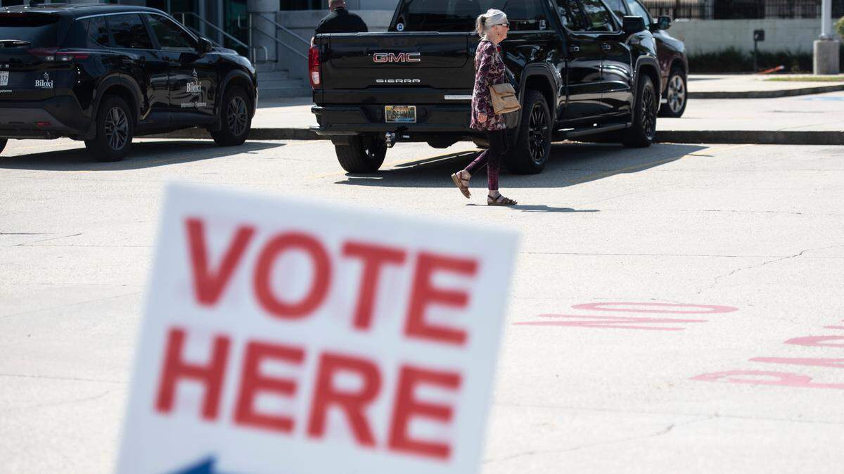 Voters enter leave the Lopez Quave Public Safety Center in Biloxi after voting in a primary election runoff on Tuesday, Aug. 29, 2023.