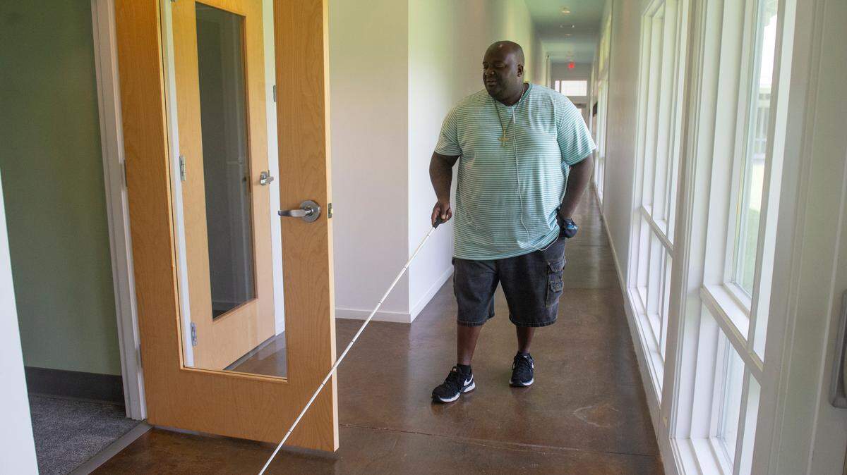 Antonio Williams, an instructor at the Mississippi Emerge Center, demonstrates how he teaches students cane navigation.