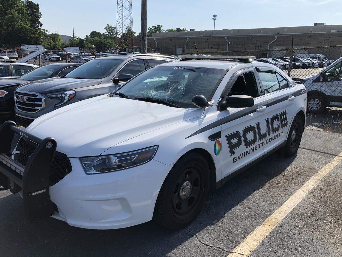 Gwinnett County police reported damage to one of its cruisers after a group of vandals reportedly tried setting it on fire.