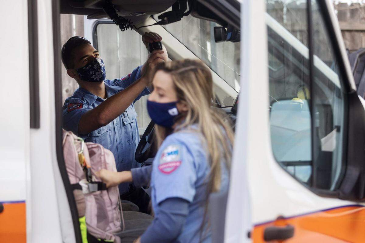 Emergency medical technician Micory Huff, left, Paramedic Haley Shafer, check their medical equipment and load their ambulance at the start of their shifts at American Medical Response in Jackson, Miss., Friday, Jan. 28, 2022.