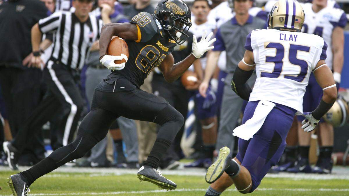 RON JENKINS/ASSOCIATED PRESS 
 Southern Miss receiver Michael Thomas (88) takes the ball in for a touchdown against Washington defensive back Brian Clay (35) during the first half of the Heart of Dallas Bowl NCAA college football game, Saturday, Dec. 26, 2015, in Dallas.
