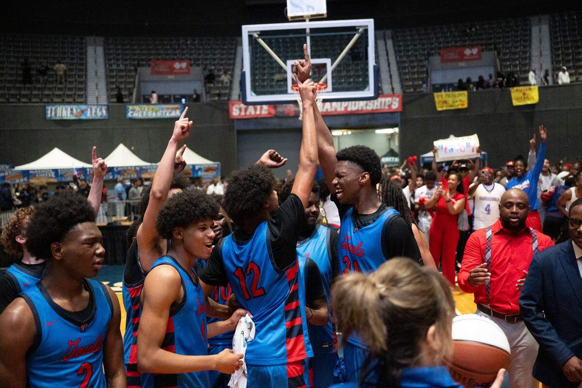 Pascagoula players celebrate the school’s first state basketball title.