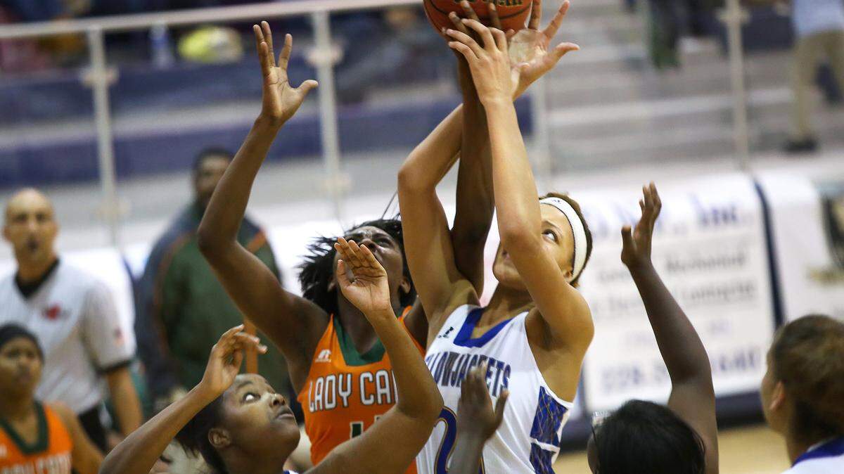 AMANDA McCOY/SUN HERALD 
 St. Martin's Jesla McCorvey, left, and Daphane White, right, battle for a rebound with West Harrison's Ameshya Williams on Tuesday, December 8, 2015, at St. Martin High. St. Martin defeated West Harrison, 64-41.