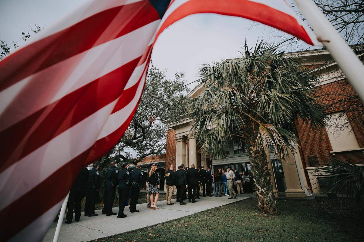 Mourners line up for the funeral service for Lt. Michael Boutte at the Bay St. Louis Community Hall on Tuesday, Feb. 9, 2021.