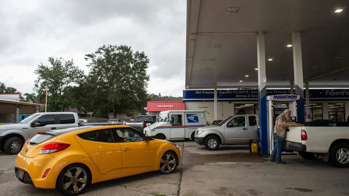 File Photo: Cars wait in line to fill up at the gas pumps at Marathon Gas Station.