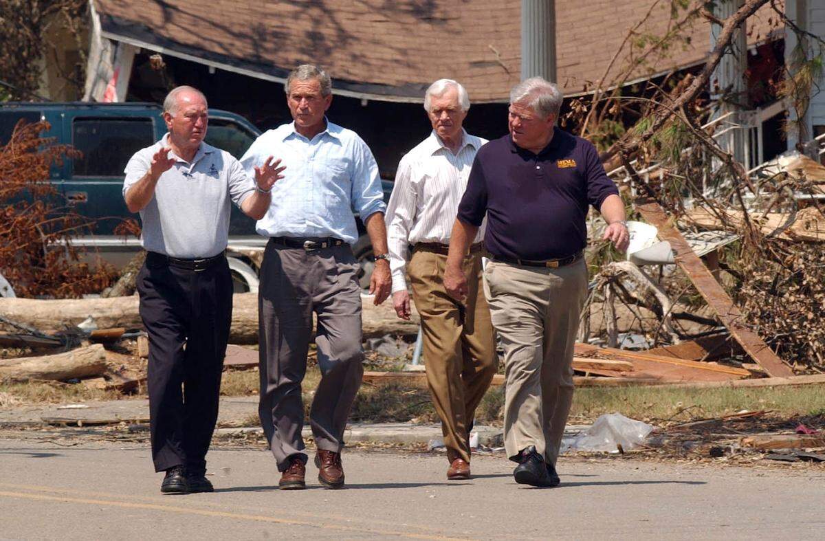 Former Biloxi Mayor A. J. Holloway confers with President George Bush they walk down Howard Avenue in Biloxi Sept. 2, 2005.. Accompanying Holloway and Bush are Mississippi senator Thad Cochran, second from right, and Gov. Haley Barbour. Cochran, who died in May, was credited with bringing considerable federal aid to the Coast after Katrina.