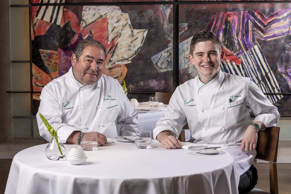 Emeril Lagasse, left, and his son E.J. Lagasse work together with the celebrity chef’s culinary team on the new direction for his flagship restaurant Emeril’s in New Orleans.