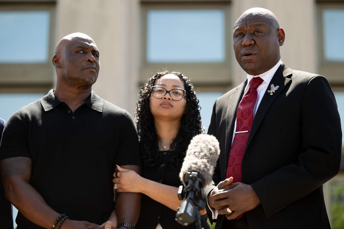 Elmore Wonsley, left, and Christine Wonsley, middle, stand together as Attorney Ben Crump answers questions during a news conference outside the Jackson County courthouse on Wednesday, July 15, 2026.