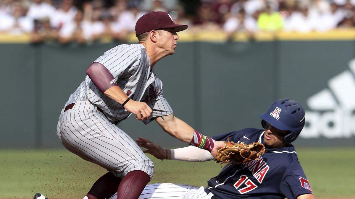 JIM LYTLE/ASSOCIATED PRESS 
 Mississippi State's John Holland tags out Arizona's Randy Labaut (17) as he slides into second base during the first inning of an NCAA college baseball tournament super regional game in Starkville Saturday.