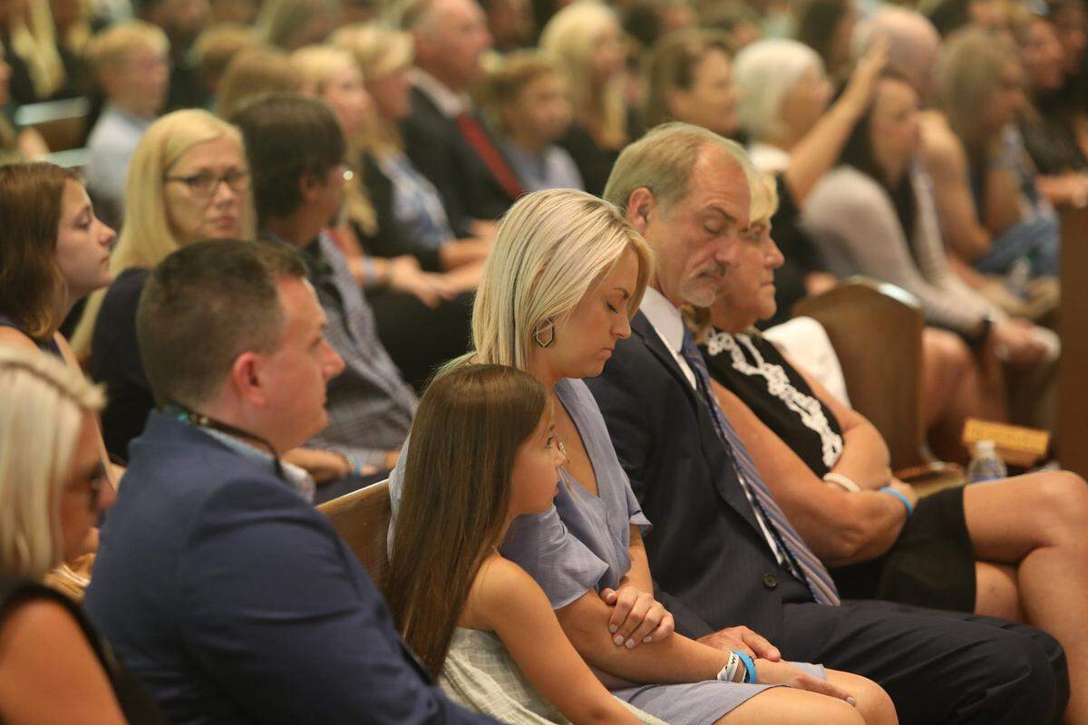 Cassie Lassabe, center, prays during mass in a funeral service for her partner, Cayce Seal, who died last week after suffering an electric shock. The funeral services were held at St. Clare Catholic Church in Waveland. Lassabe is seated next to Cayce’s parents, Doug and Michele Seal, and her daughter, Anistyn Hoda.