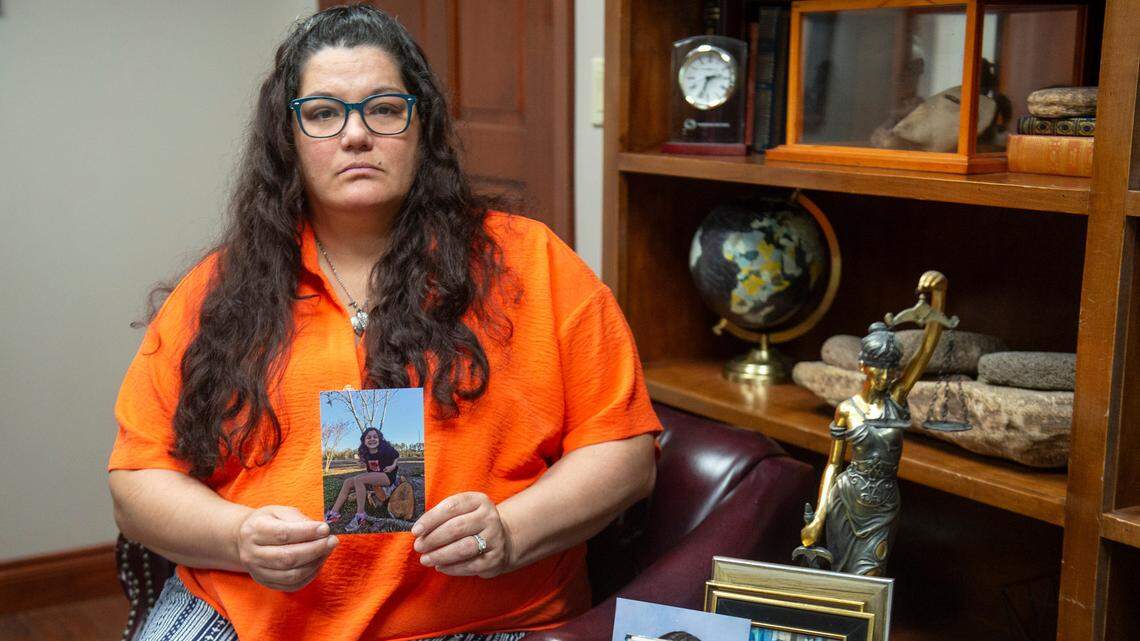 Viola Carter holds a photo of her daughter, Kayelyn Drake, as she poses for a photo in the office of her attorney, Michael Crosby, in Gulfport on Tuesday, July 16, 2024. Drake died by suicide at the Harrison County Adult Detention Center.