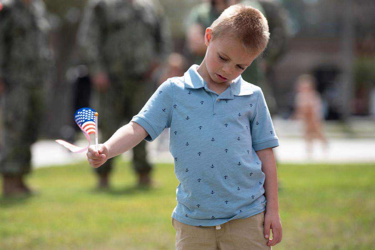 Families await the arrival of members of Naval Mobile Construction Battalion 1 as they return home from deployment on Thursday, March 13, 2025, to Naval Construction Battalion Center Gulfport.