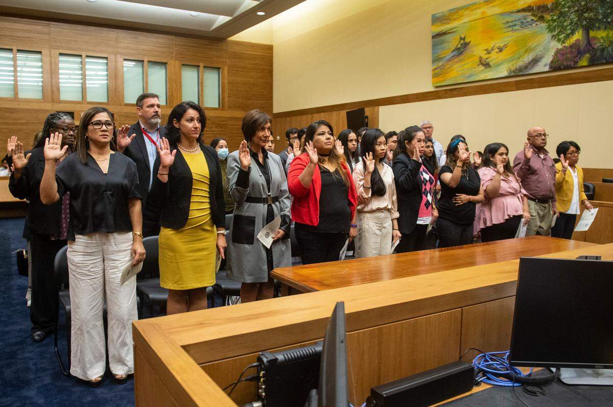 Thirty-nine new United States citizens pledge their allegiance to the United States during a naturalization ceremony at Dan M. Russell Jr. Federal Courthouse in Gulfport on Friday, Oct. 7, 2022.