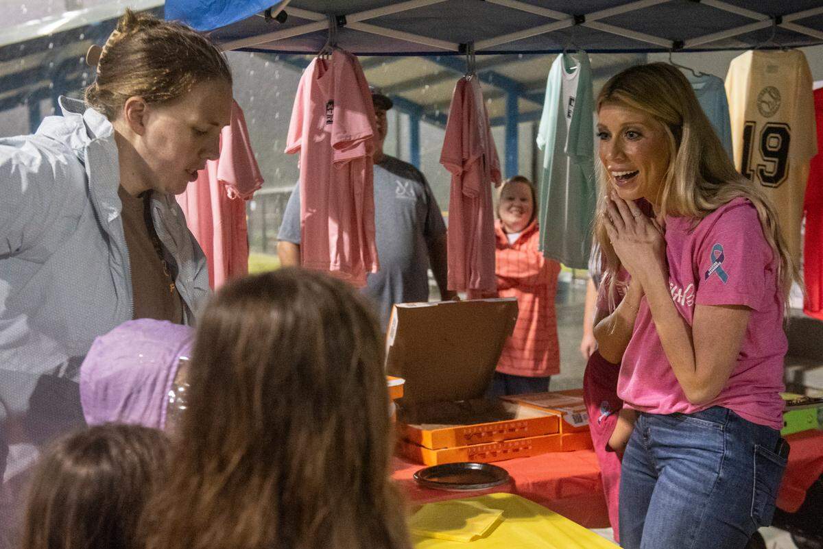 Heather Wyatt works a concession stand selling pizza and T-shirts at the opening ceremony for the Ocean Springs Girls Softball League at the Ocean Springs Sports Complex on March 4. During the ceremony, Wyatt gave a speech to the young girls, in honor of her daughter Aubreigh, about suicide prevention and bullying.
