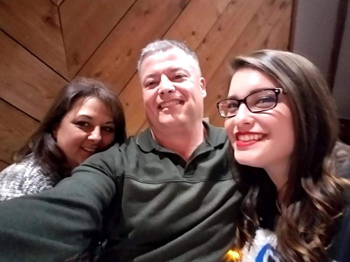 William Waltman was killed in a carjacking Wednesday. Pictured, Waltman (center) with wife, Shannon, and daughter, Kristi.