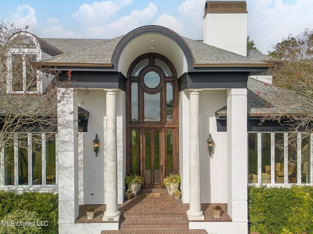 Shade falls by 1600 Beach Drive’s distinct front windows.