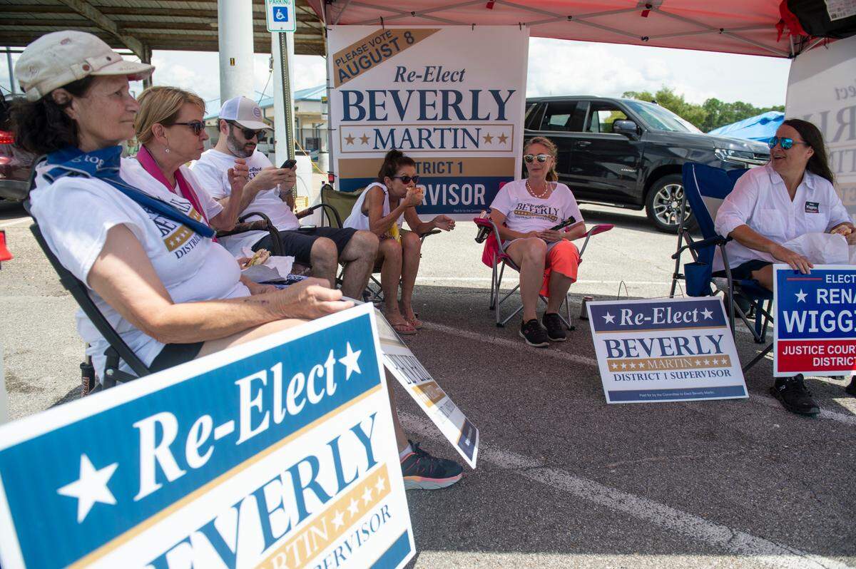 Beverly Martin, a candidate for District Supervisor 1 in Harrison County, and her supporters sit outside a polling location at D’Iberville Civic Center in D’Iberville during the Mississippi Primary Election on Tuesday, Aug. 8, 2023.