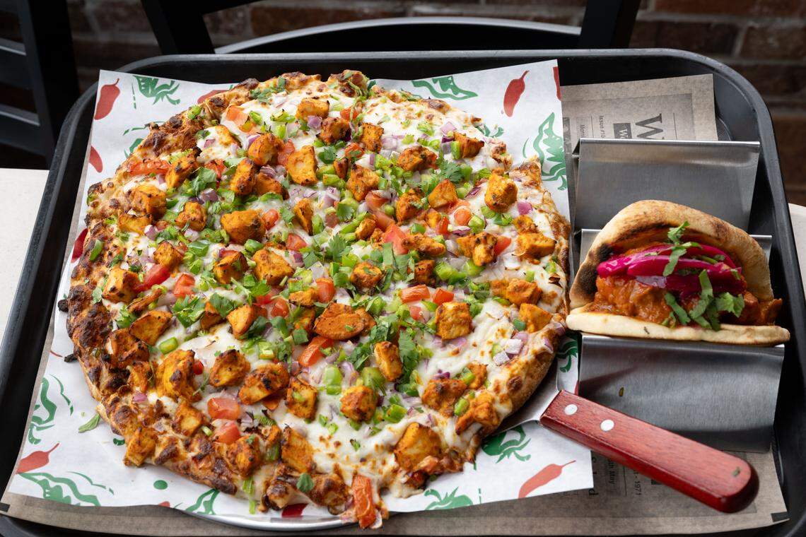 The tandoori chicken masala pizza and a butter chicken taco at I-10 Dhaba in Gulfport on Wednesday, April 22, 2026.