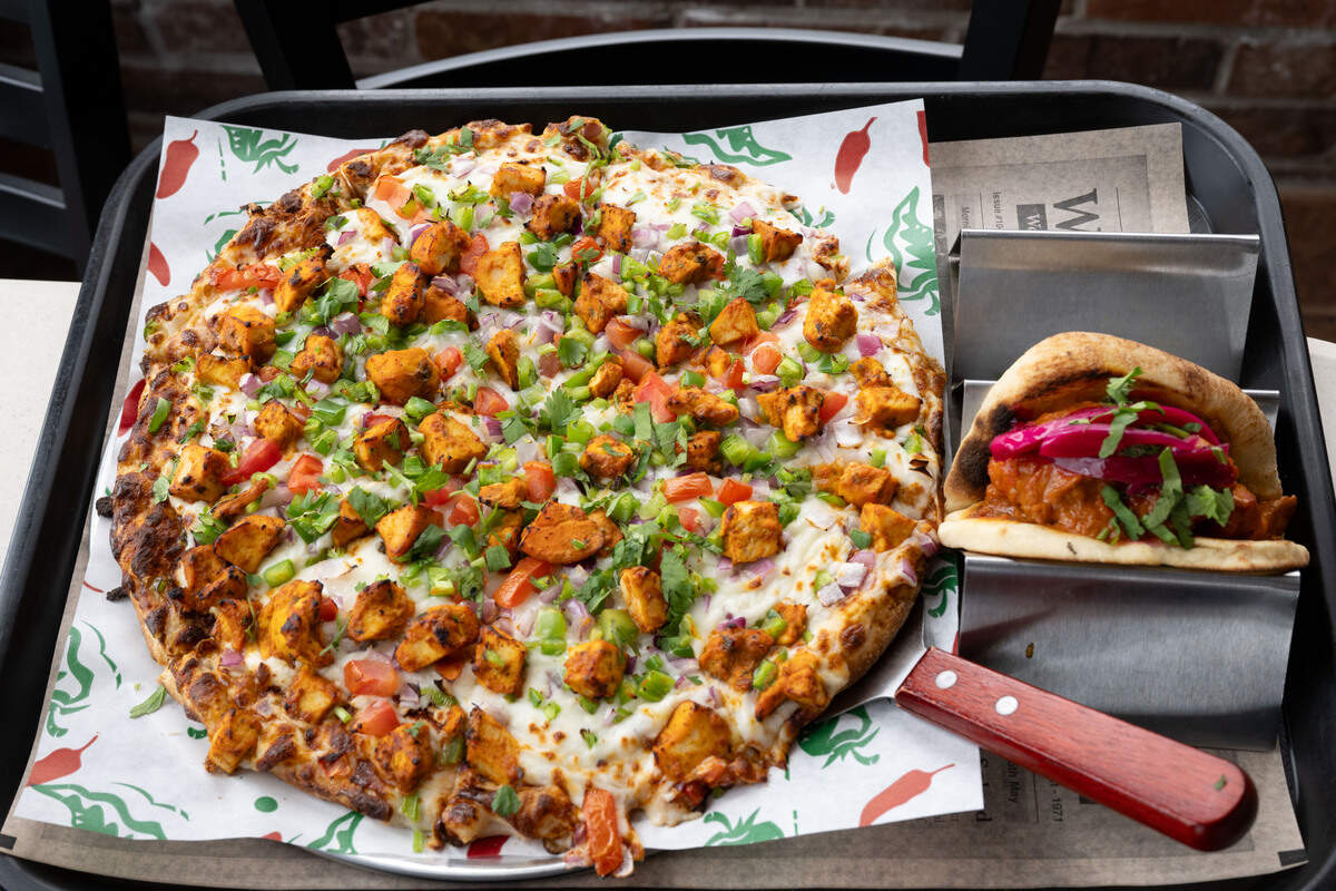 The tandoori chicken masala pizza and a butter chicken taco at I-10 Dhaba in Gulfport on Wednesday, April 22, 2026.