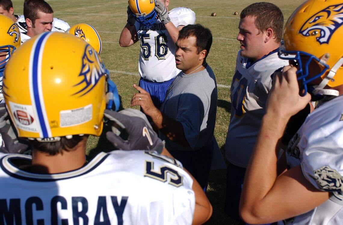 Bay High School head football coach Brenan Compretta meets with his players before practice on Tuesday, October 18, 2005.
