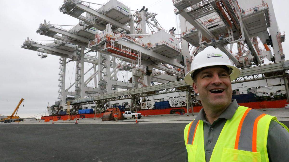 JOHN FITZHUGH/SUN HERALDPort of Gulfport director Jonathan Daniels smiles as he talks about the three new gantry cranes, left, that were delivered to the port on Friday March 18, 2016.