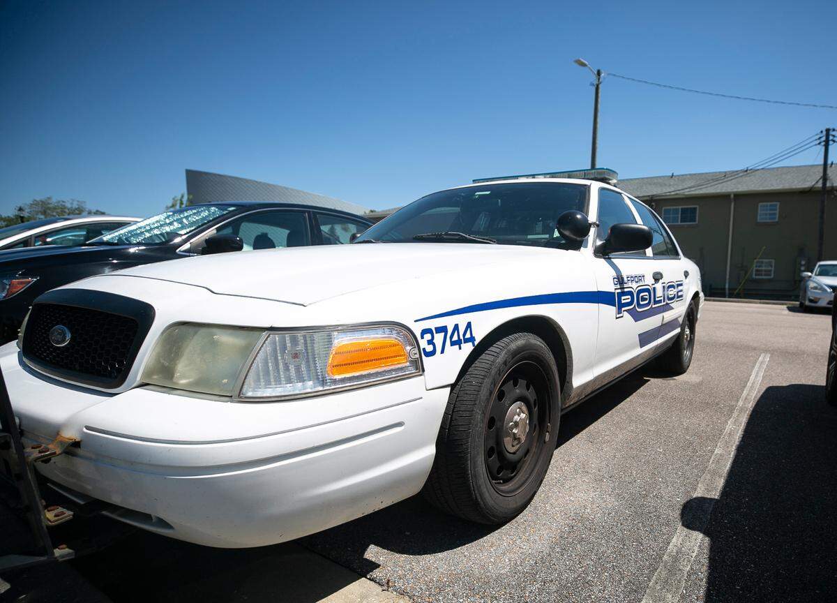 A Gulfport Police Department patrol car sits outside of the police station in downtown.