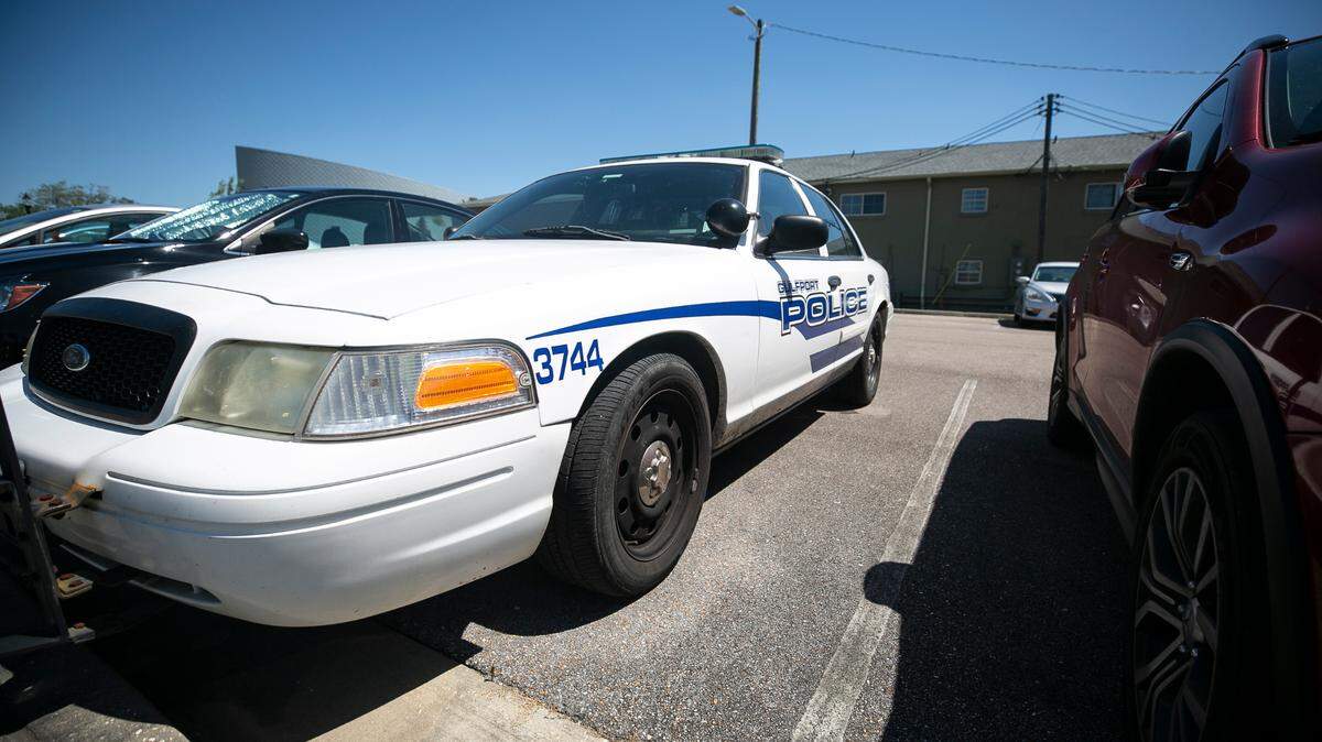 A Gulfport Police Department patrol car sits outside of the police station in downtown.