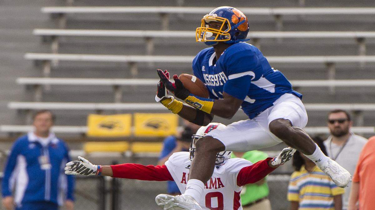 VASHA HUNT/AL.COMMississippi's D.K. Metcalf grabs a pass over Alabama's Brandon Alexander during the Mississippi/Alabama All-Star Classic.