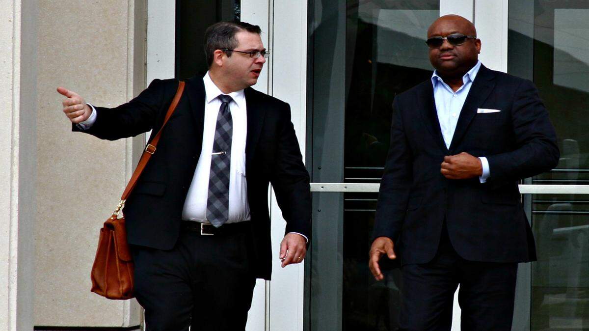 ANITA LEE/SUN HERALD 
 Gregory Warren of Lafayette, La., right, leaves U.S. District Court in Gulfport with his attorney, Luke D. Wilson, after a pretrial hearing. Warren is one of seven defendants charged in a massive BP fraud case.