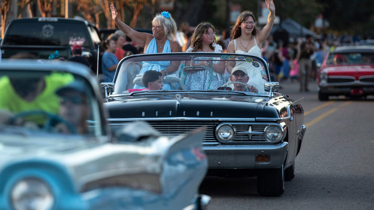 Cruisers wave to the crowd during the Long Beach Parade in Long Beach, one of the events in Cruisin’ The Coast, on Monday, Oct. 7, 2024.