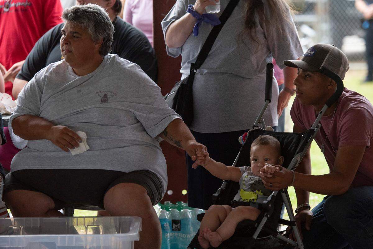 Vickie Wedgeworth Hutcherson, left, the mother of Gracelynn Vick, holds the hand of Beau, a family member’s child, during a candlelight vigil for Gracelynn at Saucier Park on Tuesday, April 22, 2025.