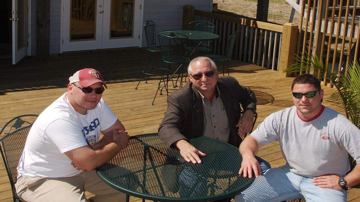 JOHN FITZHUGH/SUN HERALD/2005 
 Brothers Daniel, left, and Raleigh Murphy and their uncle, Ken Murphy, center, sit on the deck of Daniel's South Beach in Bay St. Louis in March 2005. The family-owned business transformed the former Dan B's adding an extra deck and other changes before it was destroyed by Hurricane Katrina in August 2005.