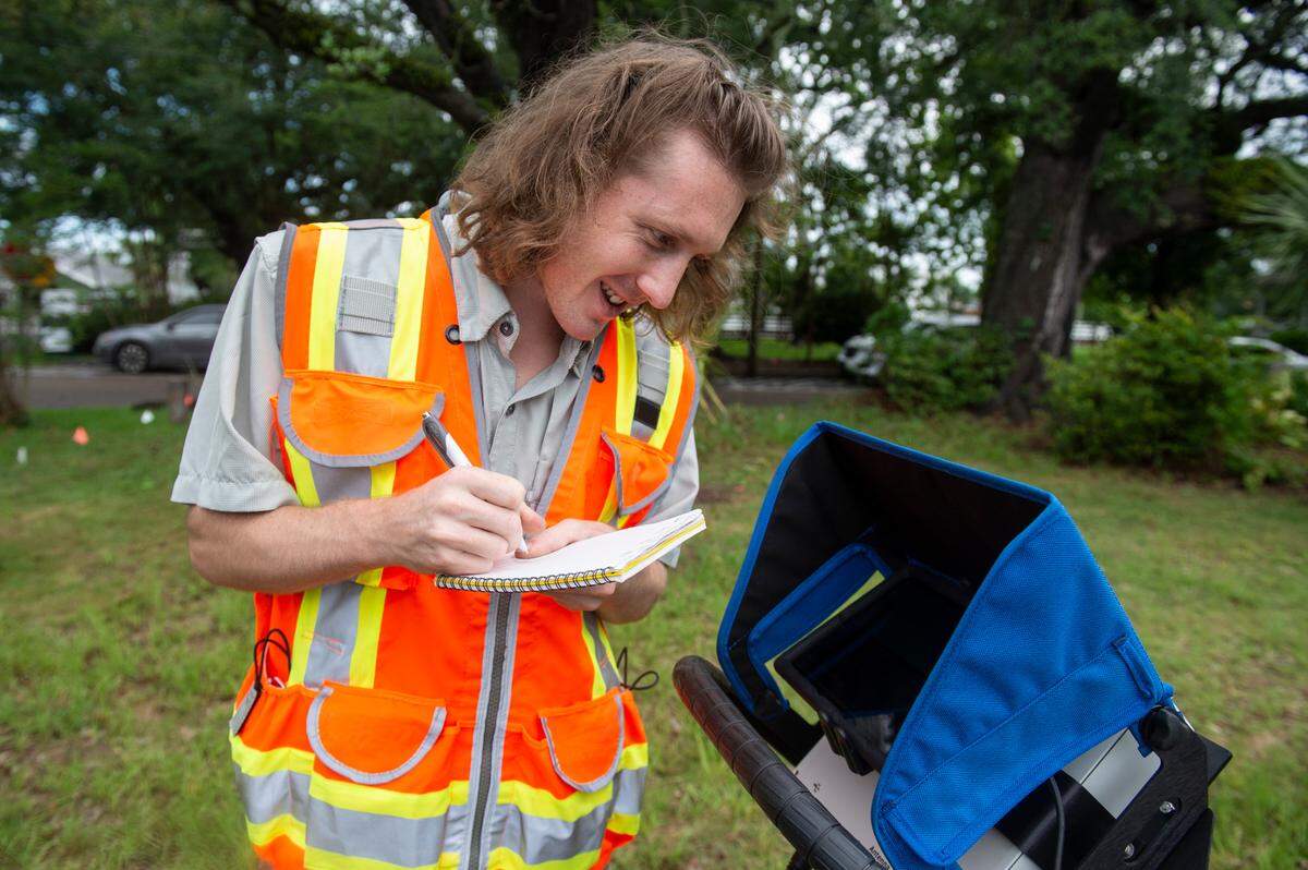 Clayton Fulgham takes notes as he looks at the data from a tree root scan after mapping out the roots on a property in Ocean Springs on Thursday, May 26, 2022. Fulgham’s father’s company, Fulgham’s Inc Tree Preservation Specialist & Consultants, uses ground penetrating radar to map out root systems in trees.