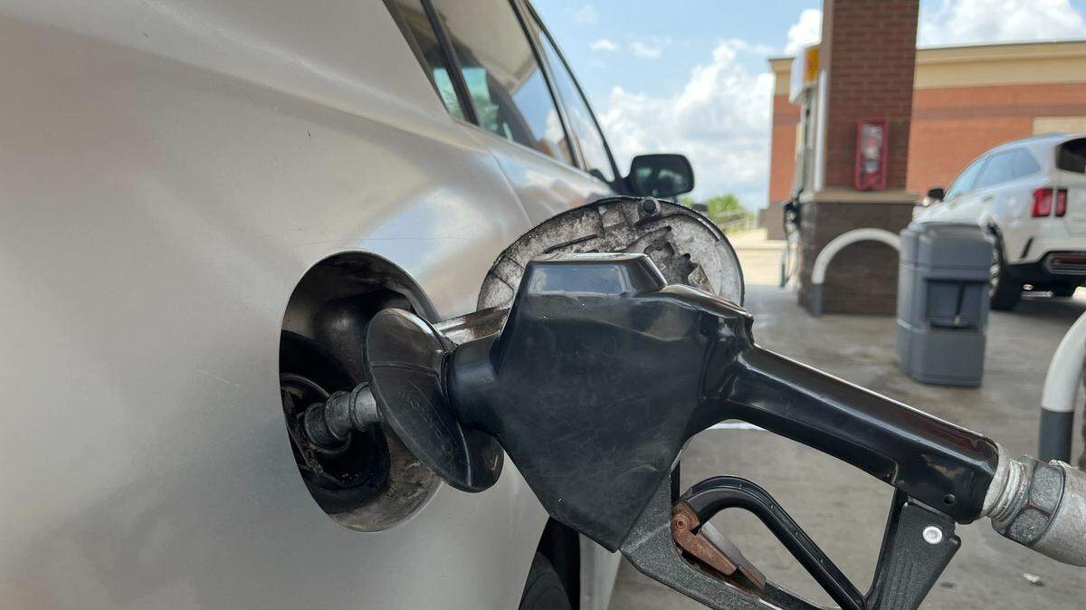 A car is refueled at a gas station.