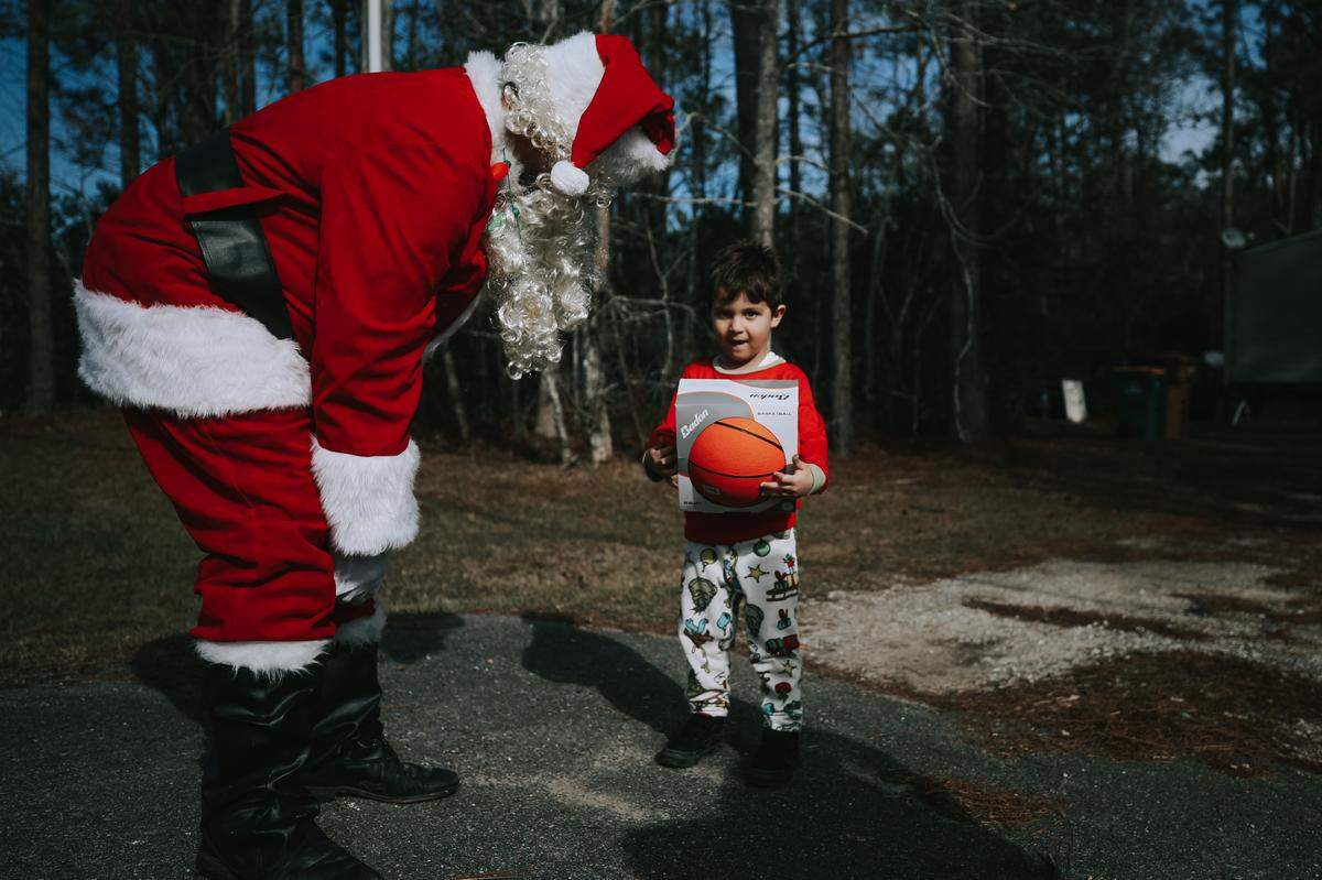 Jiobani Correa talks to Santa (Phil Dellenger) after he’s given his new basketball during his one-on-one visit Saturday, Dec. 19, 2020.