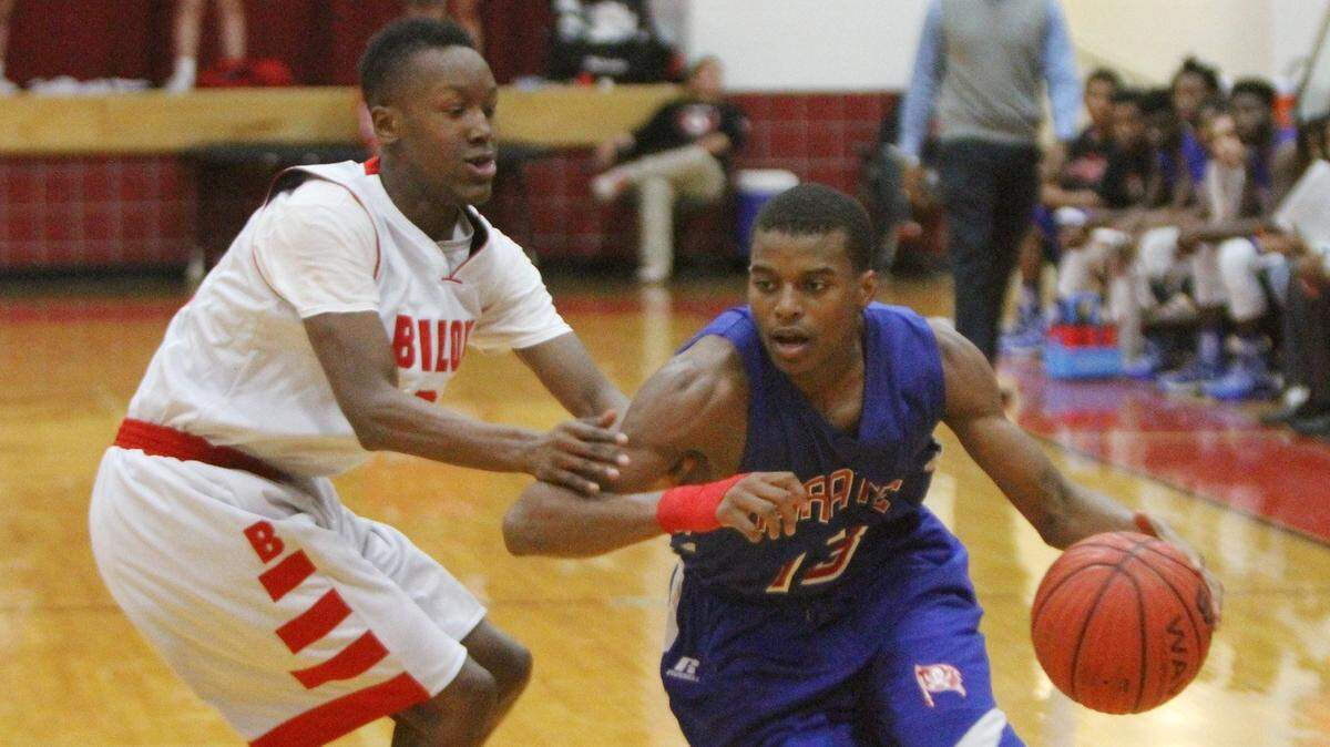 Pass Christian’s Aydarius Young drives the ball against Biloxi’s Dashawn Morgan during the second quarter of their game at Biloxi High School on Tuesday, Dec. 13, 2016.