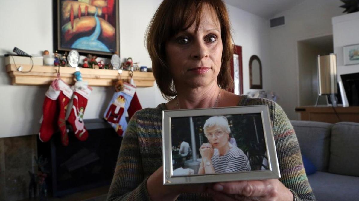 In this Dec. 14, 2017, photo in Long Beach, Calif., Birte Pfleger holds a photo of her mother, Gisela Pfleger, she made in 1994, two days before her mother was killed. Pfleger’s retired parents were visiting from Germany, when her mother was killed and her father was severely wounded in an attack by three young men in the San Jacinto Mountains of Southern California. As Pfleger faces the re-sentencing of a man who was 17 when he was ordered to serve life without parole for her mother's death, she says she knows juveniles make stupid mistakes and deserve a second chance. But not in this case. "When is the crime too horrendous to count as a mistake?" she asks.