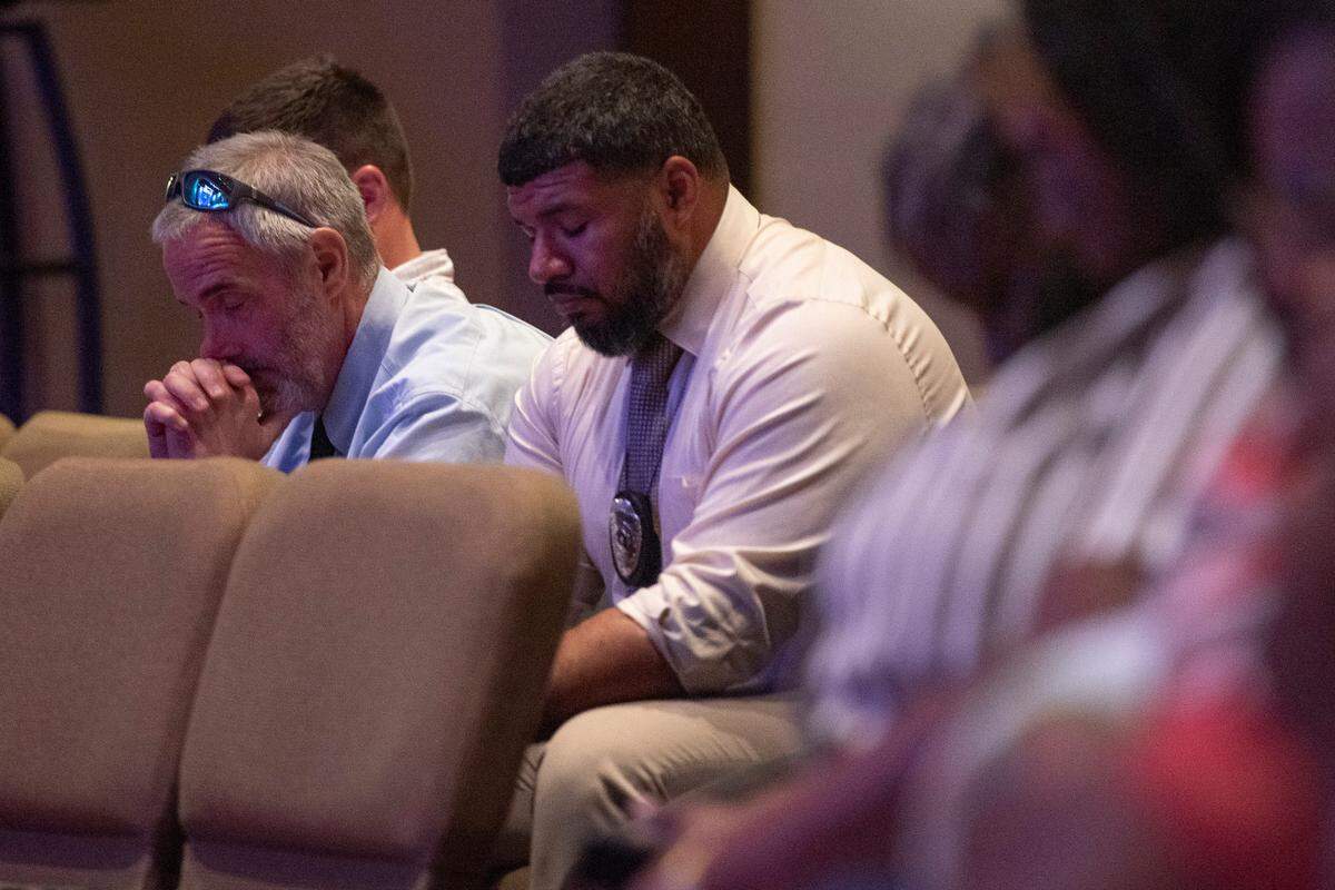 Law enforcement officers pray during a coast-wide candlelight ceremony as a part of National Crime Victims’ Rights Week at First Baptist Church of Gulfport on Tuesday, April 29, 2025.