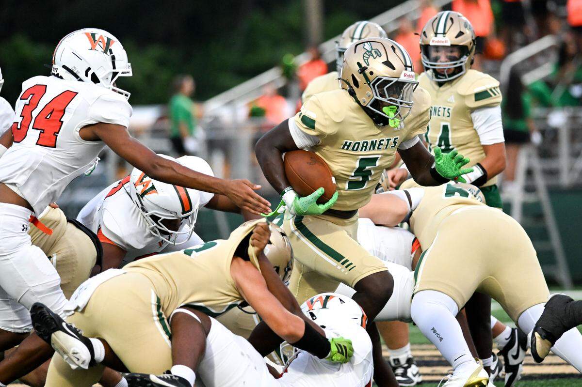 Poplarville’s Tylan Keys (5) picks up yardage Friday in the Hornets’ season-opening loss to West Harrison.