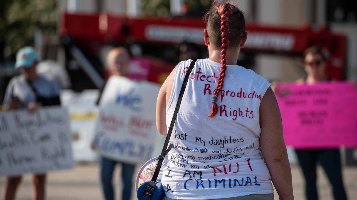 A protestor wears a shirt with her story of how reproductive rights saved her life during a protest against the Supreme Court Dobbs vs Jackson Women’s Health decision that reversed Roe vs Wade outside Dan M. Russell Jr. Courthouse in Gulfport on Friday, June 24, 2022.