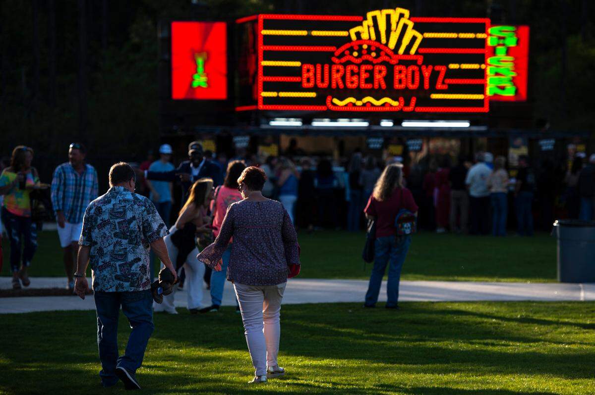 Fans walk to the concession area before the start of the KC and The Sunshine Band concert at The Sound Amphitheater in Gautier on Friday, April 12, 2024. The show marks the multi-million dollar venue’s inaugural show.