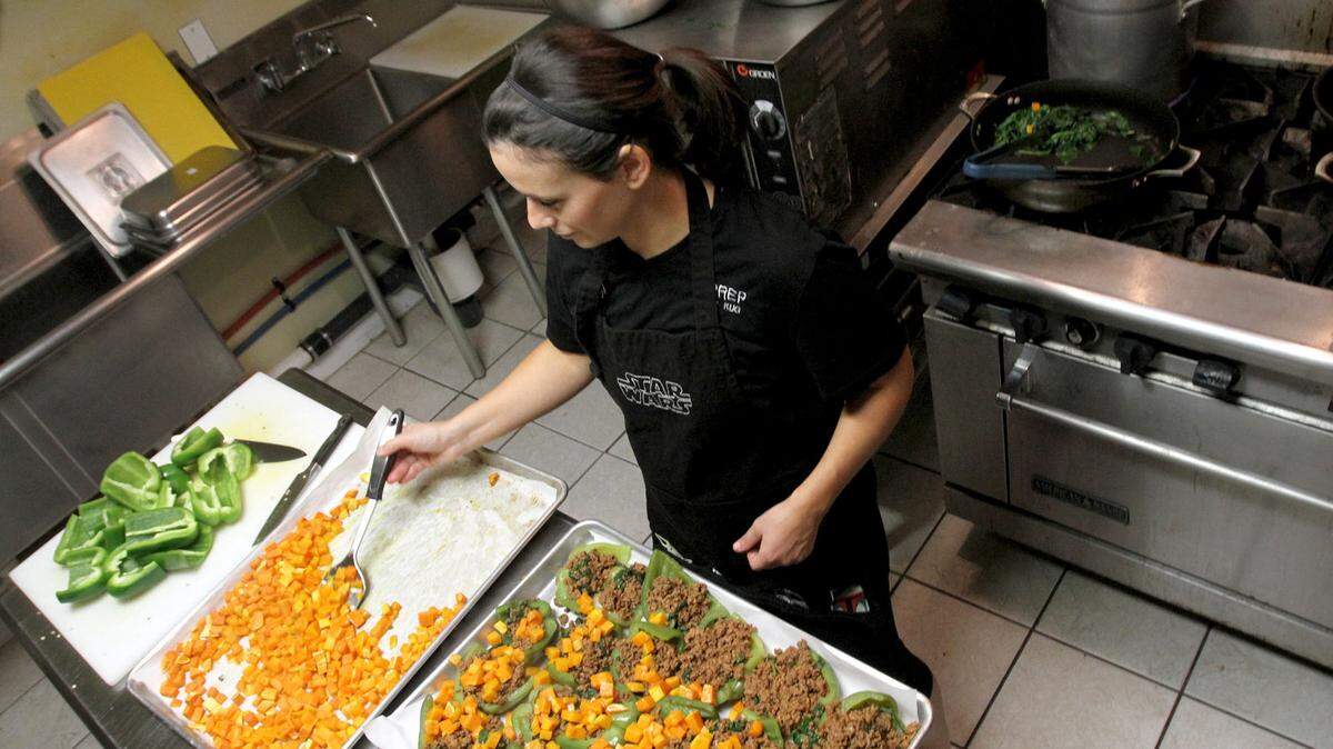 TIM ISBELL/SUN HERALDKristin Grizzard prepares stuffed peppers in Ocean Springs on Jan. 14.