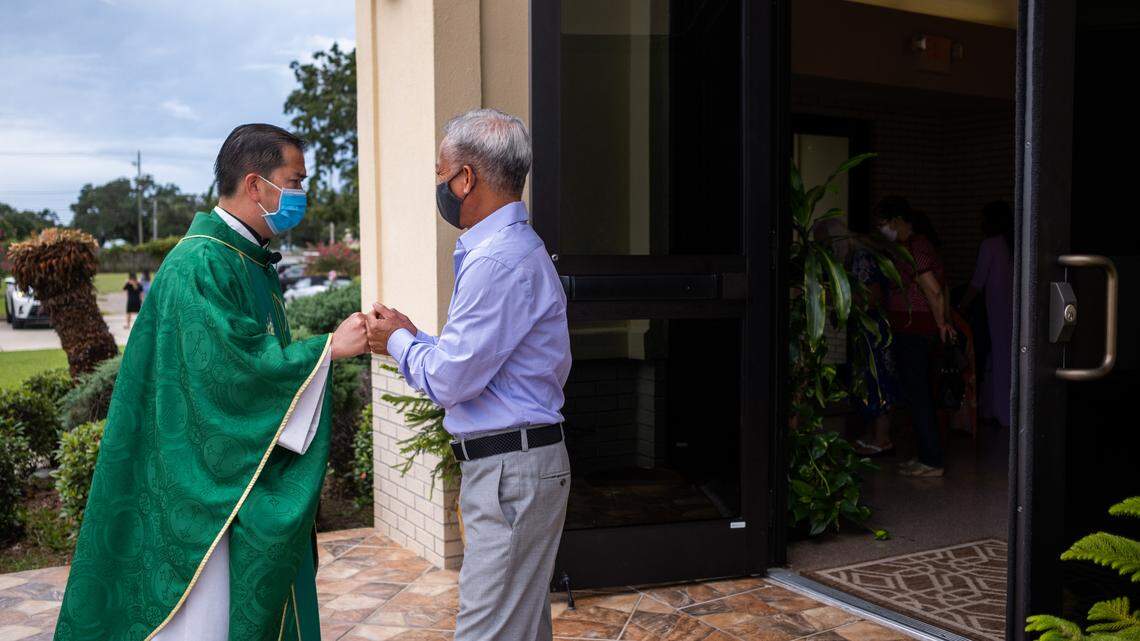 Father John Thang Pham says goodbye to a church member following the Sunday morning service at the Vietnamese Martyrs Church in Biloxi on August 23rd, 2020.