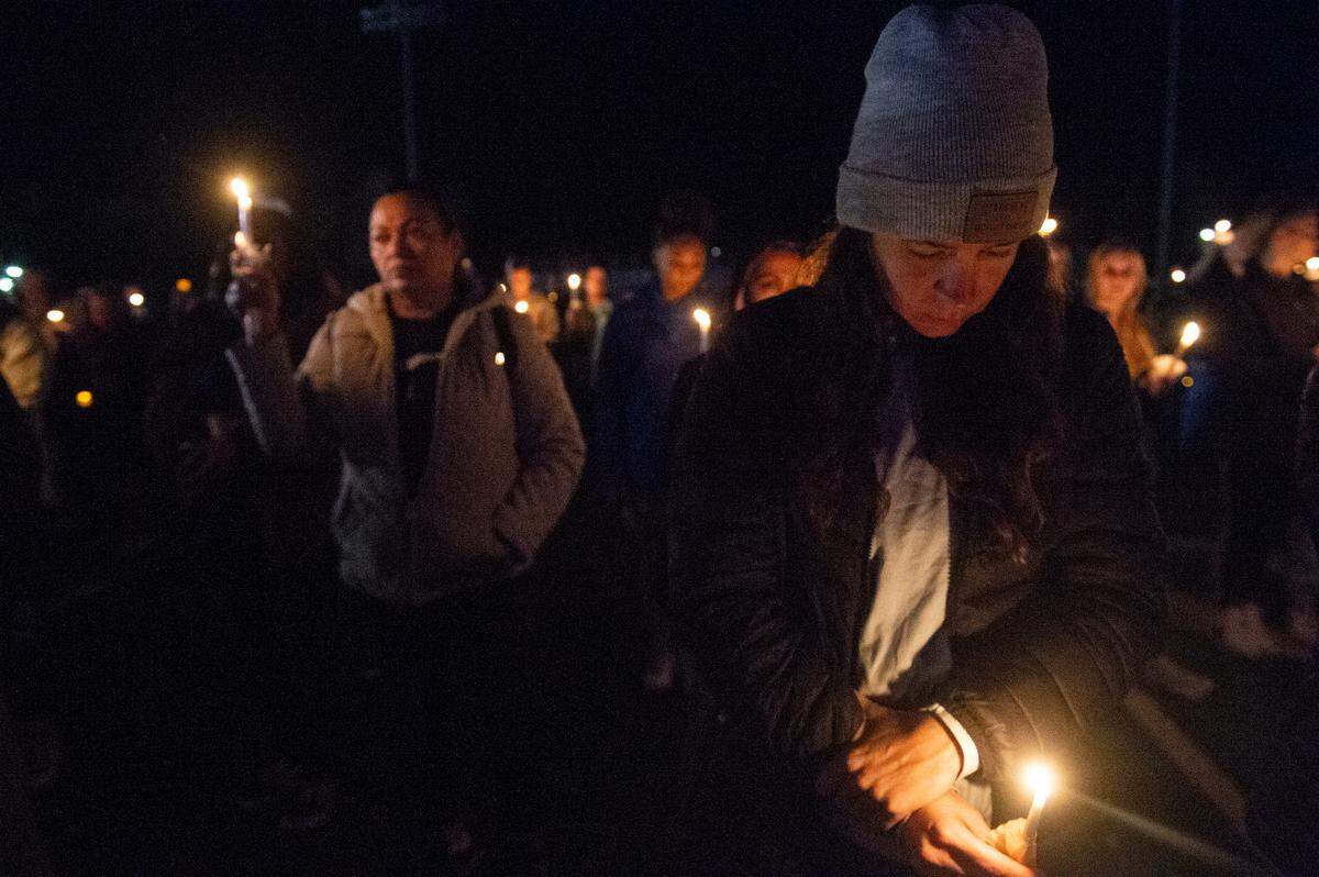 Members of the Bay St. Louis community stand with candles during a candlelit vigil for Bay St. Louis Sgt. Steven Robin and officer Branden Estorffe at Tiger Stadium in Bay St. Louis on Thursday, Dec. 15, 2022. Robin and Estorffe were killed on Wednesday when a woman shot both of them.