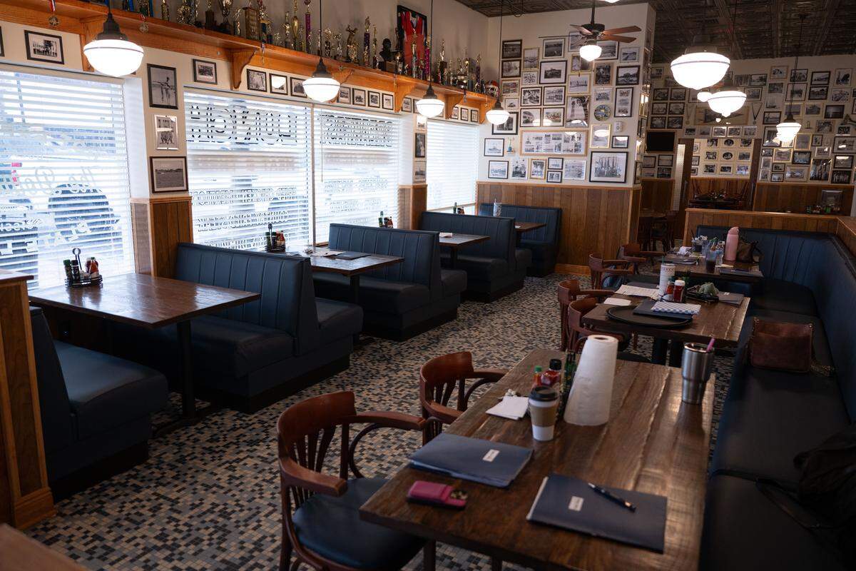 Tables and booths look out onto the streets of downtown Gulfport at The Downtowner.