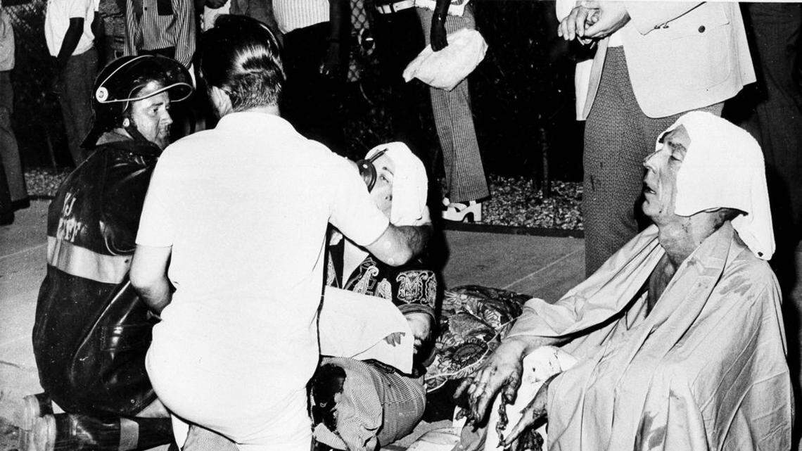 Firemen give first aid to survivors of a French Quarter fire that swept through a second story bar leaving 32 dead in New Orleans. Several persons leaped to safety before the entire bar was engulfed in flames. (AP Photo/G.E. Arnold)